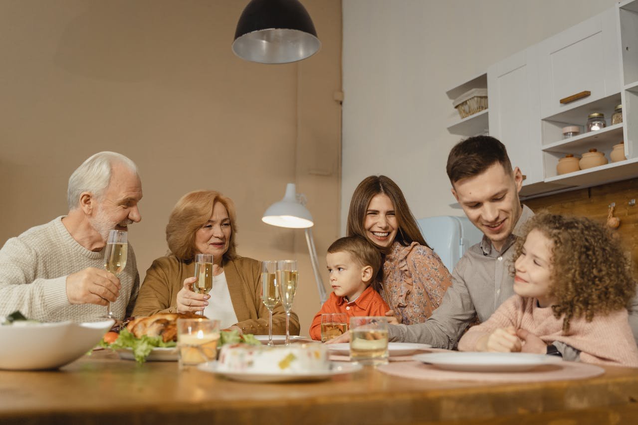 nuclear family with grandparents at a dining table